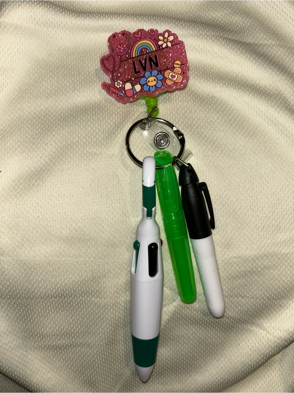 Hand Crafted Pink Glitter LVN Badge Reel with Green and White Pen Charms